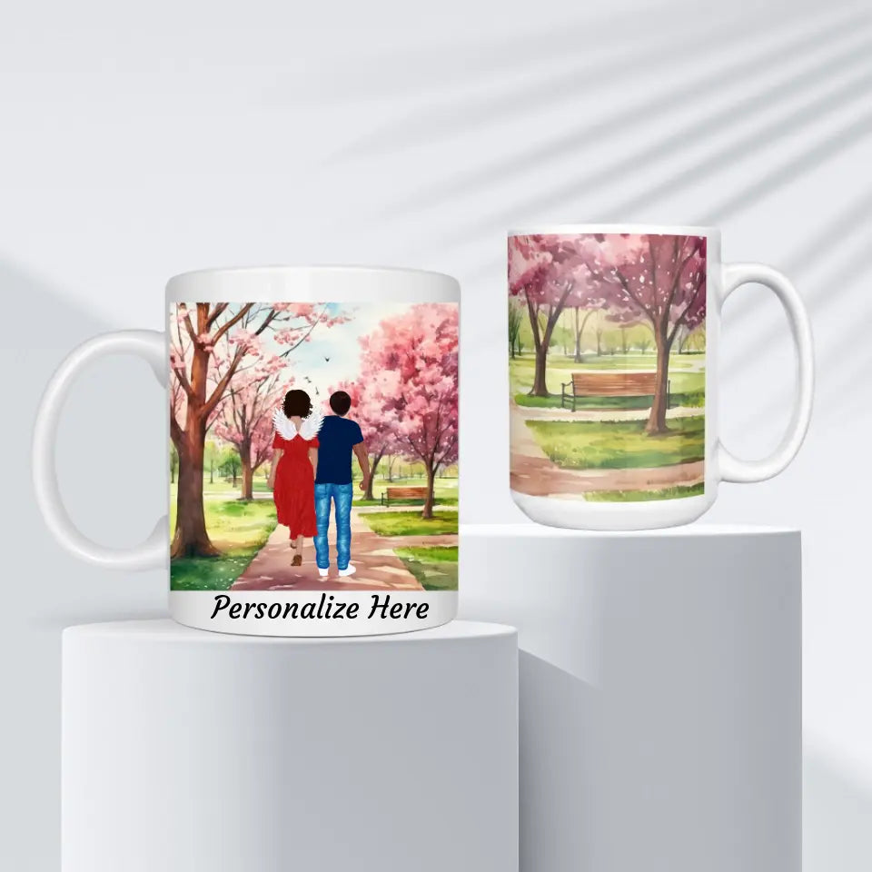 Personalized memorial mugs with springtime park scenes, offering customization for figures with options for wings, skin color, and hair, alongside a choice of quotes, available in 11oz & 15oz sizes at Grief Relief Merch on www.griefreliefsupport.com.